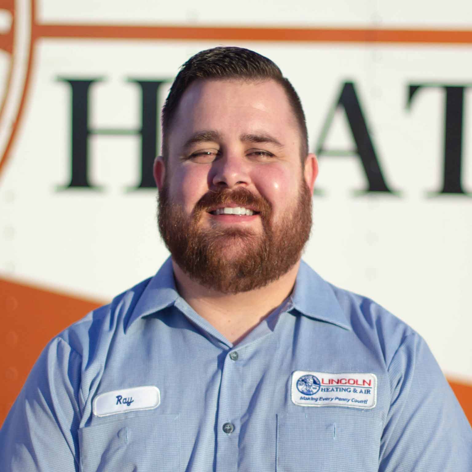 Ray L., Service Manager at Lincoln Heating & Air, smiling in front of company vehicle with logo, showcasing commitment to customer service in heating and cooling.