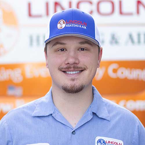 Young man in blue cap and shirt with Lincoln Heating & Air logo, representing professional customer service team atmosphere.
