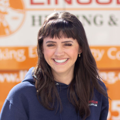 Young woman in navy hoodie at Lincoln Heating & Air, smiling against an orange and white backdrop.